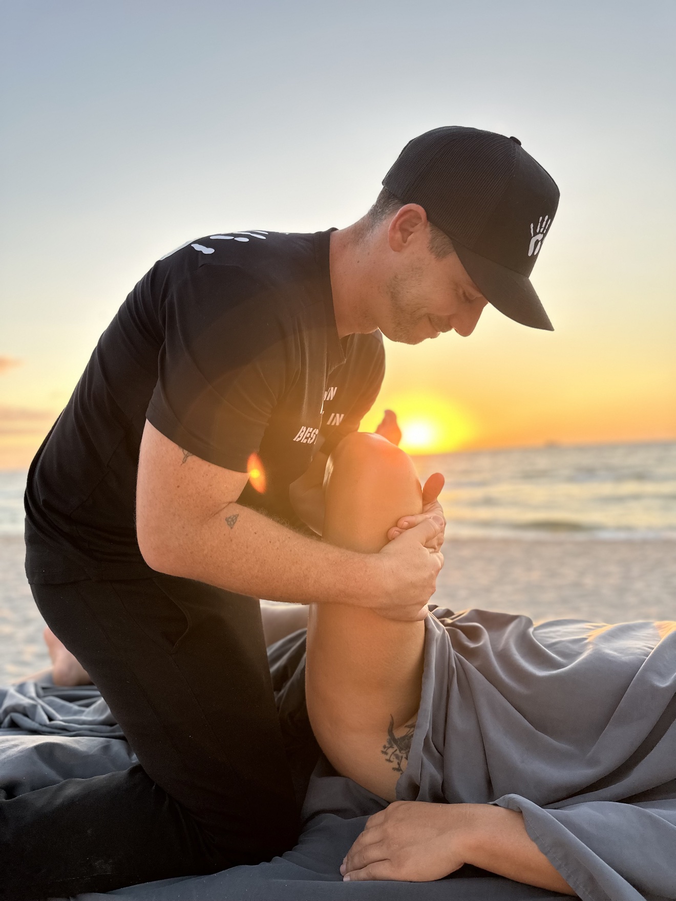 Carlos Blain performing compression work during a sports massage